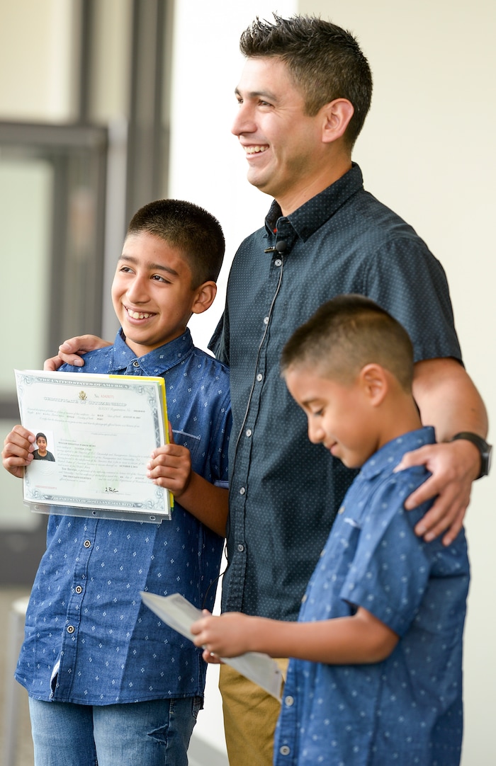 Leah Hogsten | The Salt Lake Tribune Robert Parker celebrates with his sons Sebastian Muro, 10, and Mathis Muro, 8, as American citizens after the boys' naturalization ceremony at the Viridian Event Center in West Jordan, Monday, August 6, 2018.