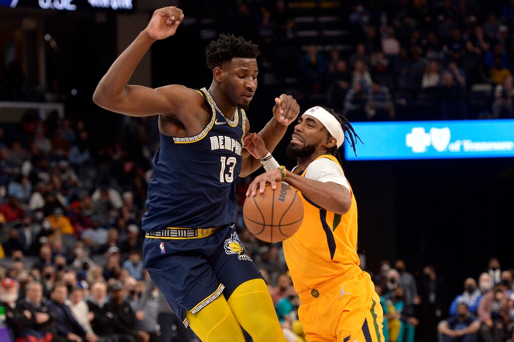 Utah Jazz guard Mike Conley handles the ball against Memphis Grizzlies forward Jaren Jackson Jr. (13) in the second half of an NBA basketball game Friday, Jan. 28, 2022, in Memphis, Tenn. (AP Photo/Brandon Dill)