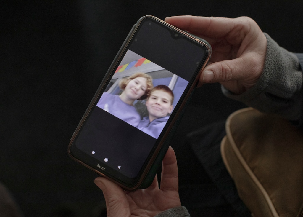 (Emile Ducke | The New York Times)
Viktoria Borysenko shows a picture of her son, Bohdan, 12, with Daria, the daughter of her sister-in-law, Nadia Borysenko, on her phone in Balakliya, Ukraine, Nov. 4, 2022. When Russians occupied the city, they took the women's children to a summer camp and have not returned them.