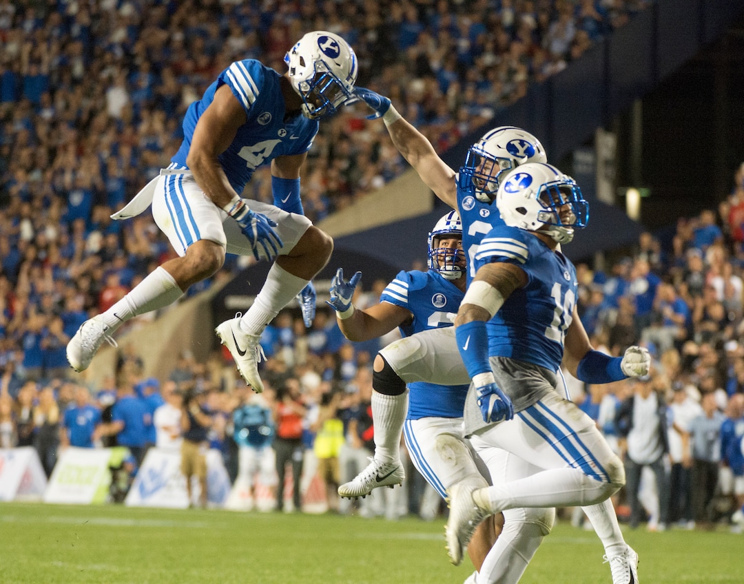 (Rick Egan  |  The Salt Lake Tribune) The Brigham Young Cougars celebrate after  linebacker Fred Warner (4) recoverd a fumble by Utah quarterback Tyler Huntley (1), in football action BYU vs Utah, at Lavell Edwards Stadium in Provo, Saturday, September 9, 2017.