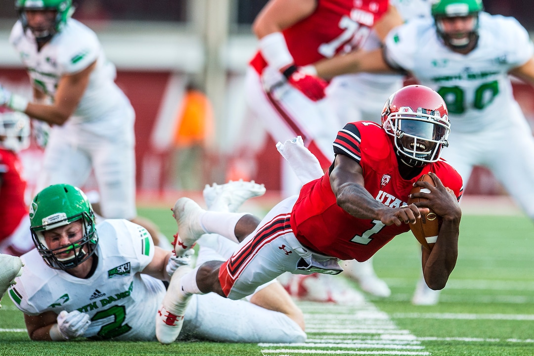 (Chris Detrick  |  The Salt Lake Tribune)  Utah Utes quarterback Tyler Huntley (1) is tackled by North Dakota Fighting Hawks linebacker Jade Lawrence (2) during the game at Rice-Eccles Stadium Thursday, August 31, 2017. Utah Utes are leading North Dakota Fighting Hawks 17-9 at halftime. 