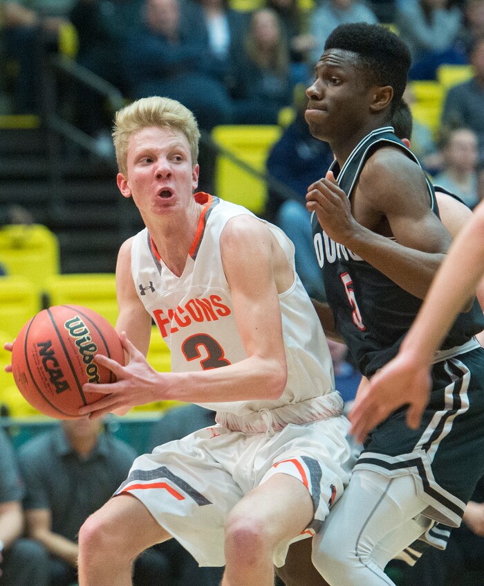 (Rick Egan  |  The Salt Lake Tribune)   Skyridge Falcons Duncan Reid (3) tries to work the ball inside as Bountiful Braves Jaxon Wood (5) defends, in 5A basketball playoff action between the Bountiful Braves and Skyridge Falcons, at the UCCU Center in Orem, Monday, Feb. 26, 2018.