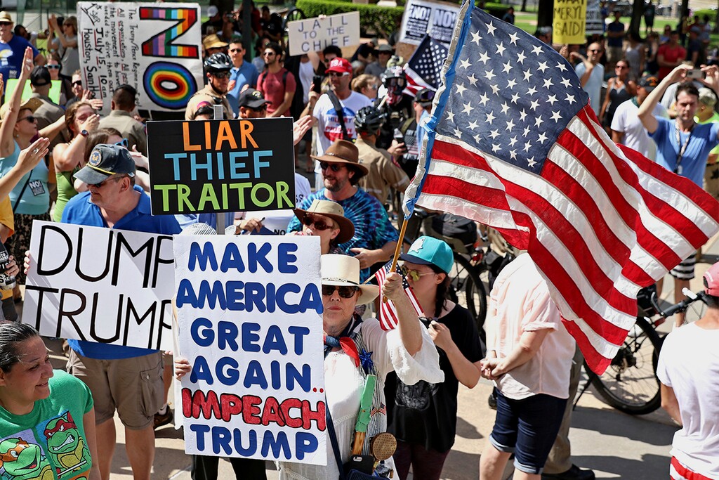 Anti-Trump supporters rally at the Texas State Capitol on Sunday, July 2, 2017, during an impeachment march  in Austin, Texas by anti-Trump supporters in hopes to gain attention and impeach Trump. (Joshua Guerra /Austin American-Statesman via AP)