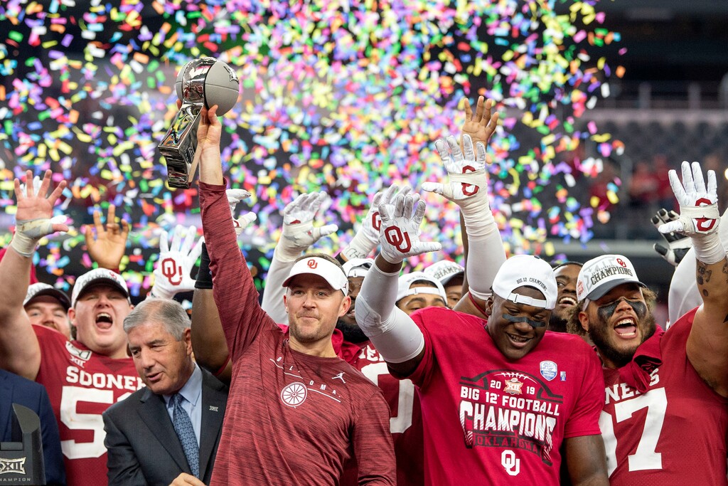 FILE - In this Dec. 7, 2019, file photo, Oklahoma head coach Lincoln Riley hosts the Big 12 Conference championship trophy after defeating Baylor 30-23 in overtime in an NCAA college football game in Arlington, Texas. On Monday, Two people familiar involved with the decision say the Big 12 will permit its teams to play one nonconference football game this year to go along with their nine league contests as plans for the pandemic-altered season continued to fall into place. (AP Photo/Jeffrey McWhorter, File)