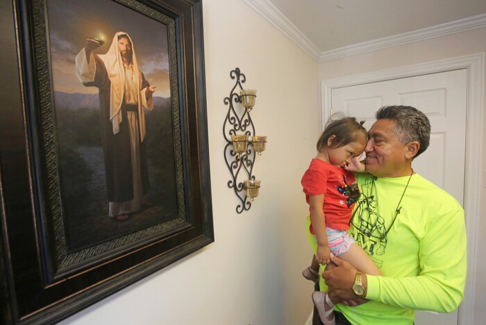 Romulo Gonzalez Rodriguez holds his 3-year-old daughter Genesis during a interview Tuesday, June 19, 2018, in Provo, Utah. Gonzalez Rodriguez spoke about the anguish of being separated from his 3-year-old daughter, Genesis Gonzalez Lopez, for seven days in November after arriving to the U.S. port of entry in San Diego. Gonzalez Rodriguez said he fled his hometown of Champerico, Guatemala to seek asylum in the United States after he was kidnapped and extorted by captors who cut his eye out and nearly killed him. (AP Photo/Rick Bowmer)