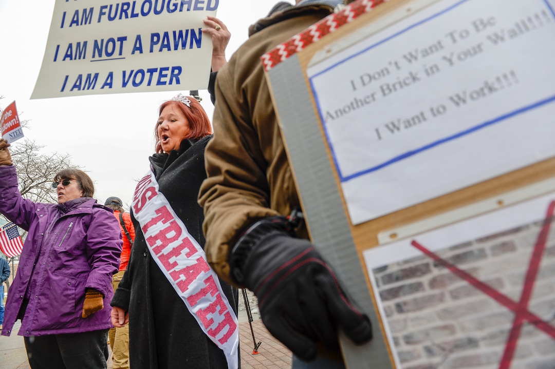 Leah Hogsten  |  The Salt Lake Tribune  Wearing a handmade "Miss Treated" banner, Marae Persson, a 16 year employee with the Internal Revenue Service joins fellow employees in protest of the ongoing partial federal shutdown outside the Federal Building in Ogden, Jan. 10, 2019.
