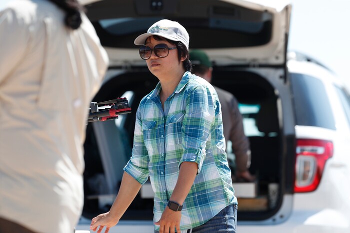 (David Zalubowski | AP Photo) In this Thursday, July 11, 2019, photograph, Huihui Zhang at a research farm northeast of Greeley, Colo. Researchers are using drones carrying imaging cameras over the fields in conjunction with stationary sensors connected to the internet to chart the growth of crops in an effort to integrate new technology into the age-old skill of farming.