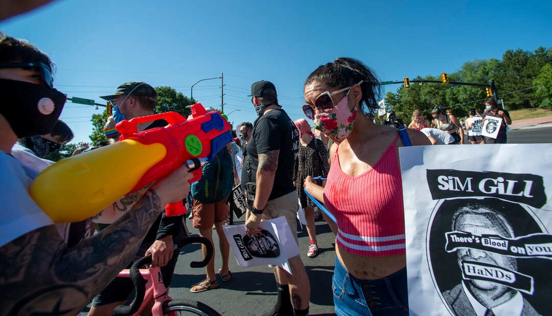(Rick Egan  |  The Salt Lake Tribune)     Cassidy Priest shoots water on protesters, as they dance in the streets, during a march for Justice on Sunday, July 12, 2020.
