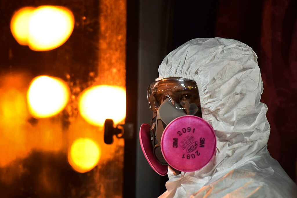 (Muzzafar Kasim | Malaysia's Ministry of Health via AP) In this photo released by Malaysia's Ministry of Health, a health worker wearing a full protective suit waits for the arrival of evacuated Malaysians from China's Wuhan, the epicenter of the new coronavirus outbreak, at Kuala Lumpur International Airport in Sepang, Malaysia, Wednesday, Feb. 26, 2020.