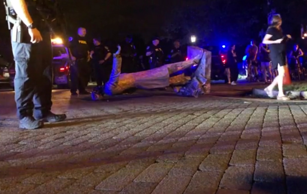 (WWBT-TV via AP)
In this image from video, police stand near a toppled statue of Jefferson Davis on Wednesday night, June 10, 2020, in Richmond, Va. Protesters tore down the statue of Confederate President Davis along Monument Avenue. The statue in the former capital of the Confederacy was toppled shortly before 11 p.m., news outlets reported.