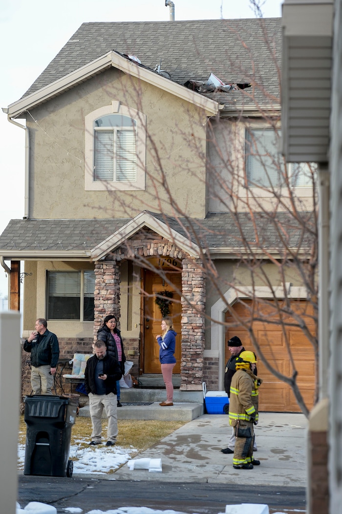(Leah Hogsten | The Salt Lake Tribune) Weber County emergency personnel and firefighters work the scene of a small, private plane that crashed in a residential neighborhood in Roy, Jan 15, 2020. A 64-year-old pilot was killed.