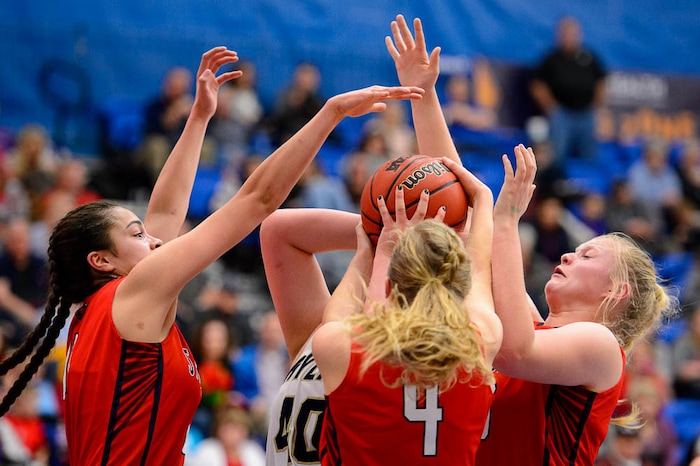 (Trent Nelson | The Salt Lake Tribune)  Springville's Kallysta Strong (11), Springville's Brooke lynn Galbraith (4), and Springville's Addisyn Johnson (33) defend Skyline's Cameron Mooney (40) as Skyline faces Springville in the 5A High School Girls' Basketball Tournament at SLCC in Taylorsville, Wednesday Feb. 21, 2018.