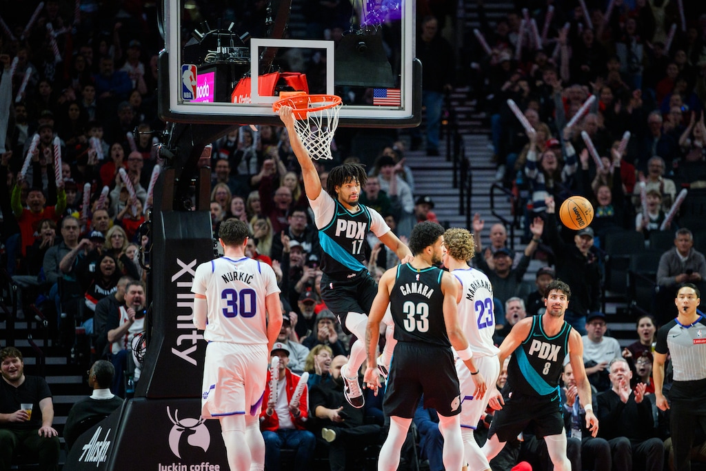 (Molly J. Smith | AP) Portland Trail Blazers guard Shaedon Sharpe (17) hangs off the rim after a dunk during the second half of an NBA basketball game against the Utah Jazz, Monday, Jan. 5, 2026, in Portland, Ore. 