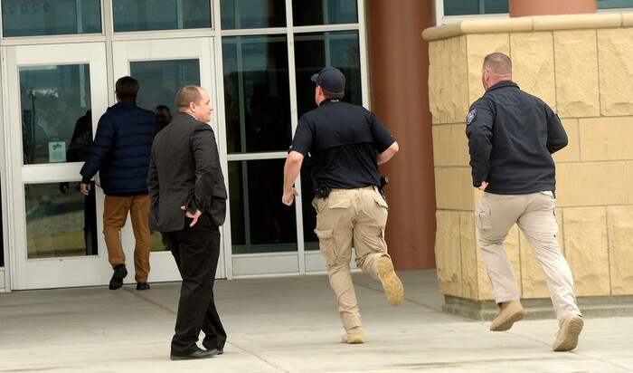 (Al Hartmann  |  The Salt Lake Tribune) 	
School rescource officers sprint to the front entrance at Westlake High School in Saratoga Springs to break up a fight between two students after 80 students left class and stood together in silence at the front entrance of the school Wednesday March 14, 2018 to remember the 17 students who died in a school shooting in Florida.  