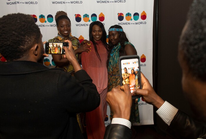 (Rick Egan | The Salt Lake Tribune) Guests snap photos of some of models, Sandrine Ingabire, Burundi, Noon Taha , Sudan, and Margaret Mathew, South Sudan, after they walked the runway, at the 9th annual Women of the World Fashion Show Gala, Wednesday, March 6, 2019.