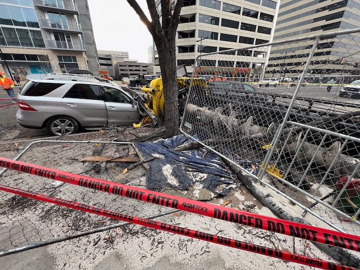 (Francisco Kjolseth | The Salt Lake Tribune) The aftermath of a piece of construction equipment Wednesday, March 16, 2022, after it collapsed on to State Street Tuesday night, crushing vehicles and sending one worker to the hospital.