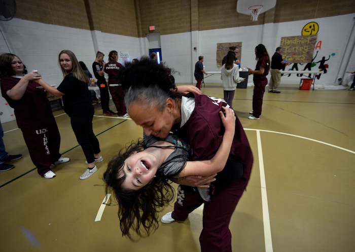 (Scott Sommerdorf   |  The Salt Lake Tribune)   Inmate Angela Rekoutis spins her daughter Ava in the prison gymnasium during "Kids Day" at the Utah State Prison, Saturday, October 7, 2017. There were games and snacks set up in the gymnasium, and an outside area in the prison yard was also available for play.