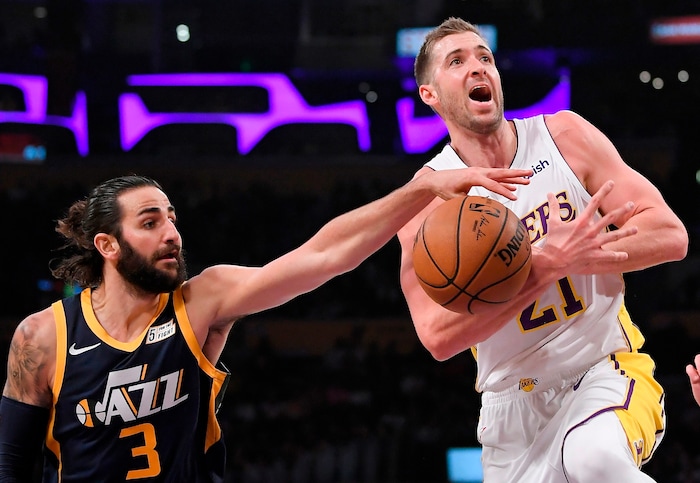Utah Jazz guard Ricky Rubio, left, of Spain, reaches in against Los Angeles Lakers forward Travis Wear as Wear tried to shoot during the first half of an NBA basketball game Sunday, April 8, 2018, in Los Angeles. (AP Photo/Mark J. Terrill)