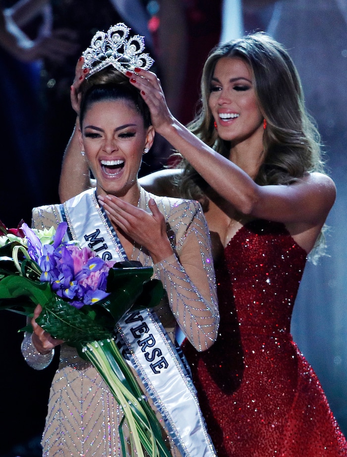 (John Locher | The Associated Press) Former Miss Universe Iris Mittenaere, right, crowns new Miss Universe Demi-Leigh Nel-Peters at the Miss Universe pageant Sunday, Nov. 26, 2017, in Las Vegas.