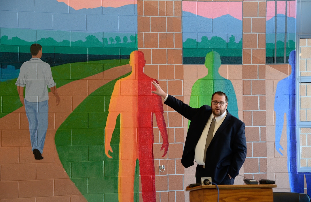 (Francisco Kjolseth  |  The Salt Lake Tribune) Juvenile Justice Services Director Brett Peterson at Decker Youth Center in West Valley City describes a mural in the multipurpose room meant to illustrate the positive transformation of youth working through the juvenile justice system. Peterson gave a tour on Wednesday, Jan. 15, 2020, to discuss its success after juvenile justice reforms were passed in 2017. Gov. Gary Herbert was on hand to tour the facility and speak with some of the youth who are being held at the facility.