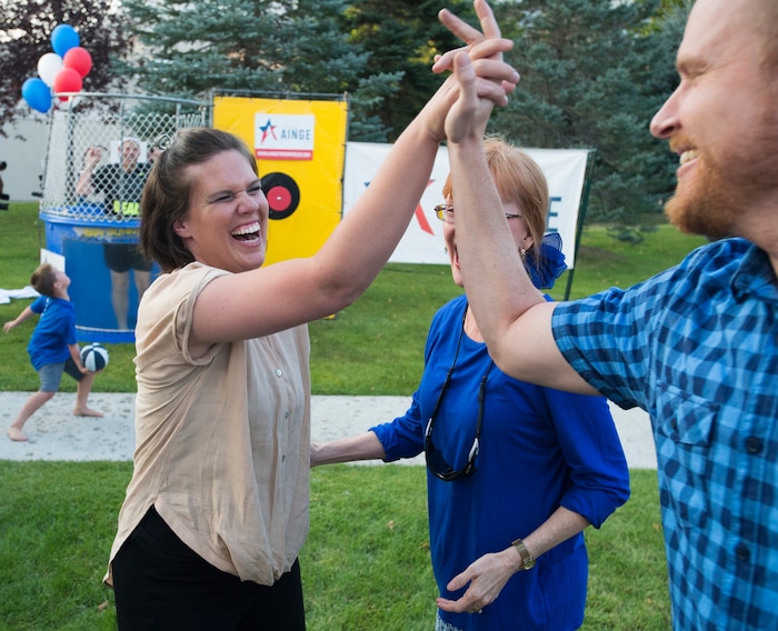 (Rick Egan  |  The Salt Lake Tribune)  Aubrey Farnsworth and Scott Warner celebrate after Farnsworth dunked Danny Ainge in a dunking booth, during a fundraiser in Provo for Tanner Ainge, who is running for congress, in Utah’s third district. Monday, August 7, 2017.