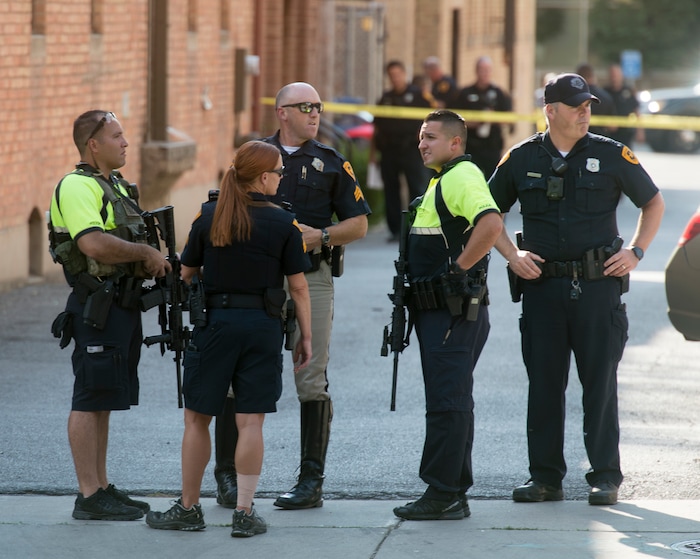 (Rick Egan  |  The Salt Lake Tribune)   Police stand by on 400 south across from Pioneer Park, after a suspect that fired shots at a police officer was found dead in a nearby building, of an apparent self-inflicted gunshot.  Wednesday, Sept. 5, 2018.


