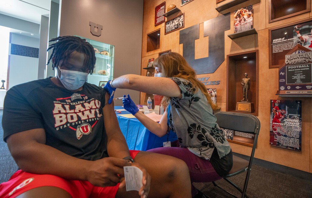 (Rick Egan | The Salt Lake Tribune) Melanie Hall administers a COVID-19 vaccination to Braeden Daniels, at the Spence and Cleone Eccles Football Center at a vaccination clinic at the University of Utah, Tuesday, June 29, 2021. Some U. students now want a vaccination requirement to attend classes in person.