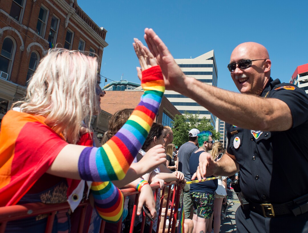 (Rick Egan  |  The Salt Lake Tribune)    Salt Lake Police Chief Mike Brown, high- fives parade goers as he walks in the Utah Pride Parade,  in Salt Lake City, Sunday, June 3, 2018.
