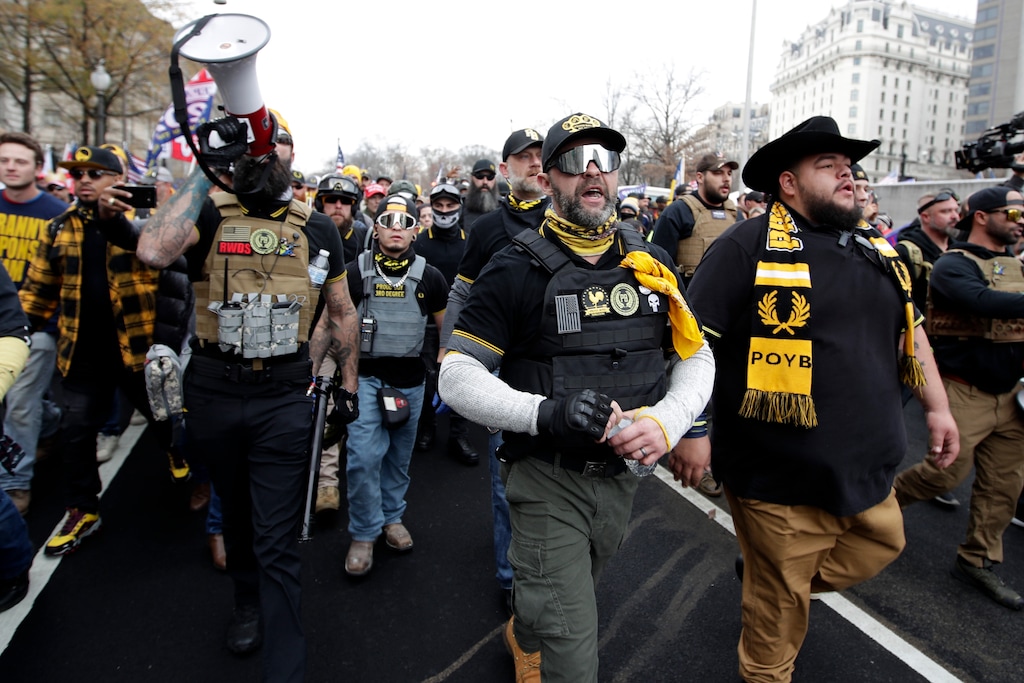 Supporters of President Donald Trump who are wearing attire associated with the Proud Boys attend a rally at Freedom Plaza, Saturday, Dec. 12, 2020, in Washington. (AP Photo/Luis M. Alvarez)