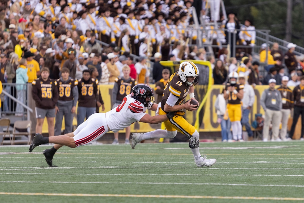(Matthew Idler | AP) Utah defensive end John Henry Daley, left, sacks Wyoming quarterback Kaden Anderson.
