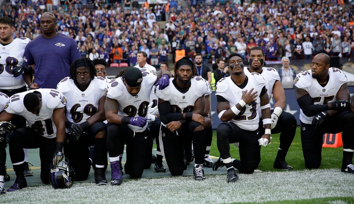 Baltimore Ravens players kneel down during the playing of the U.S. national anthem before an NFL football game against the Jacksonville Jaguars at Wembley Stadium in London, Sunday Sept. 24, 2017. (AP Photo/Matt Dunham)