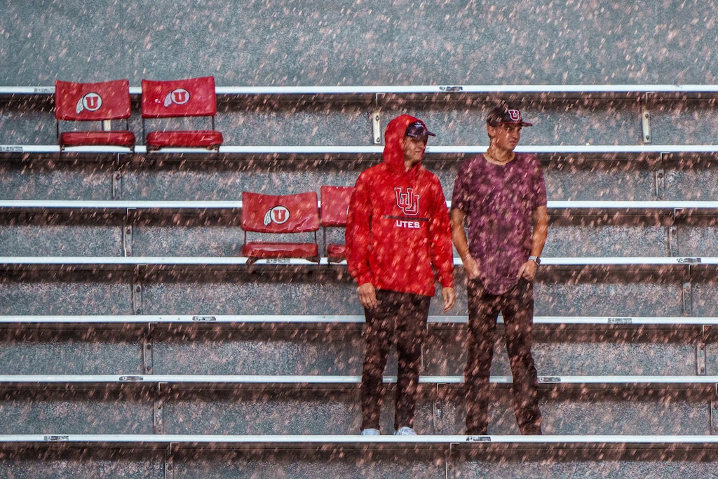 (Trent Nelson | The Salt Lake Tribune) Rain pours down on fans during a lightning delay as the University of Utah's football team hosts the Weber State Wildcats in Salt Lake City on Thursday, Sept. 2, 2021. Rain is possible during Utah's home opener this week.