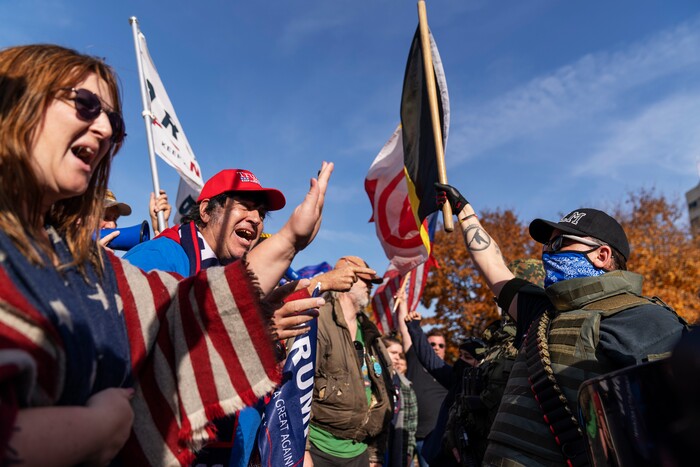 Trump supporters, at left, demonstrating the election results are confronted by counter protesters at the State Capitol in Lansing, Mich., Saturday, Nov. 7, 2020.  Democrat Joe Biden defeated President Donald Trump to become the 46th president of the United States on Saturday, positioning himself to lead a nation gripped by the historic pandemic and a confluence of economic and social turmoil.(AP Photo/David Goldman)