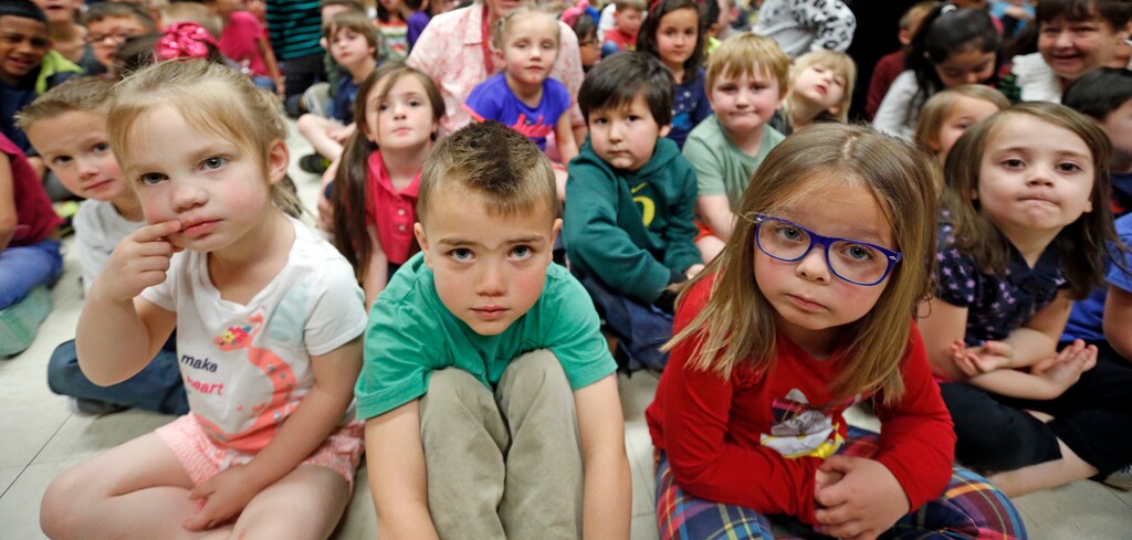 Students from the Meadowbrook Elementary School watch as Utah Gov. Gary Herbert signs a bill at the Meadowbrook Elementary School Monday, April 16, 2018, in Bountiful, Utah. Herbert signed the bill creating a path to raise education funding in a deal lawmakers reached with a well-connected group of business, political and education leaders. (AP Photo/Rick Bowmer)