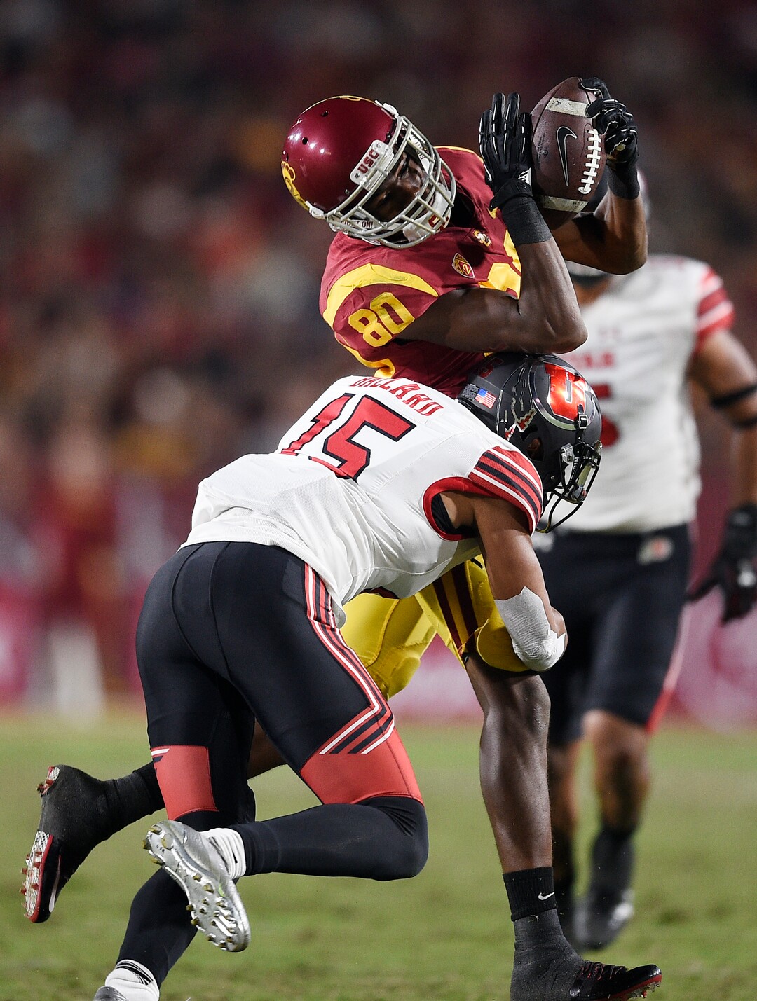 Southern California wide receiver Deontay Burnett, top, catches the ball while being hit by Utah defensive back Corrion Ballard during the second half of an NCAA college football game in Los Angeles, Saturday, Oct. 14, 2017. USC won 28-27. (AP Photo/Kelvin Kuo)