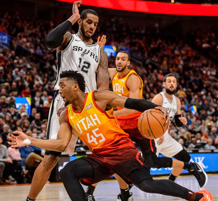 (Trent Nelson | The Salt Lake Tribune)  
Utah Jazz guard Donovan Mitchell (45) drives around San Antonio Spurs center LaMarcus Aldridge (12) as the Utah Jazz host the San Antonio Spurs, NBA basketball in Salt Lake City on Saturday Feb. 9, 2019.