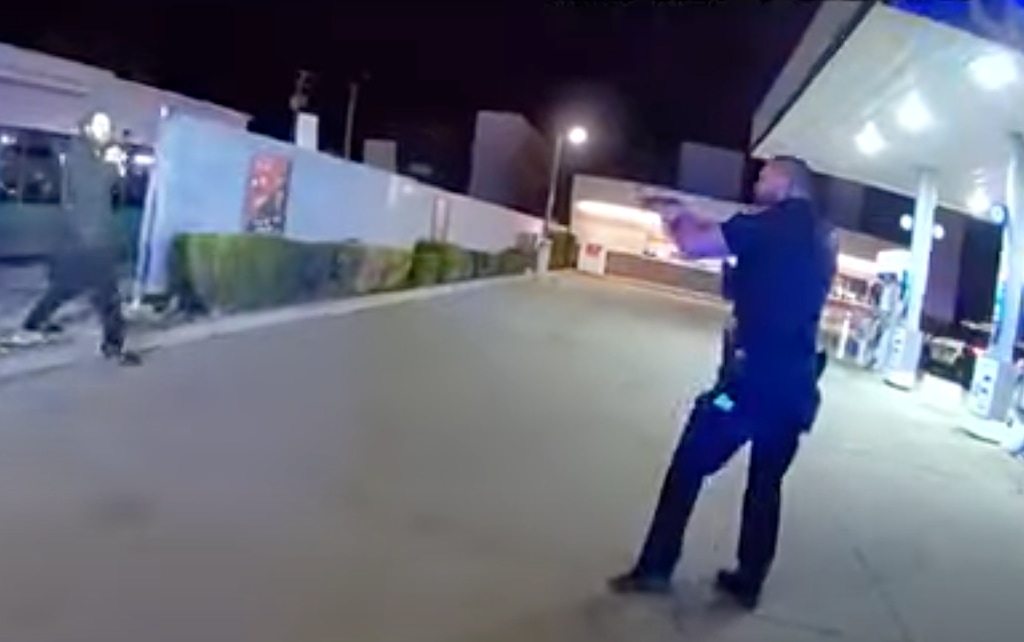 (Salt Lake City Police Department) A Salt Lake City police officer aims his gun at 36-year-old Cameron Ammon Cloward on April 2, 2024, seconds before officers open fire on Cloward, killing him. Cloward, who appears to be holding a pocketknife in the footage, had reportedly threatened to stab a convenience store employee and didn't listen to police commands to drop the knife or get on the ground.