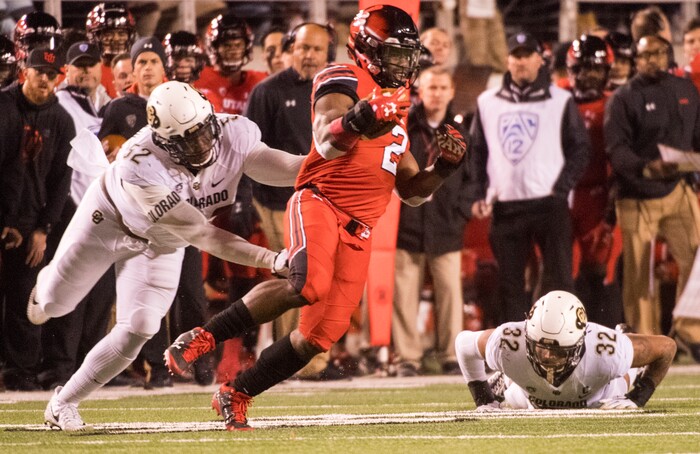 (Rick Egan  |  The Salt Lake Tribune)  Utah Utes running back Zack Moss (2) gets past Colorado Buffaloes defenders Colorado Buffaloes defensive end Leo Jackson III (52) and Colorado Buffaloes linebacker Rick Gamboa (32), in PAC-12 football action Utah Utes vs. Colorado Buffaloes at Rice-Eccles stadium, Saturday, November 25, 2017.


