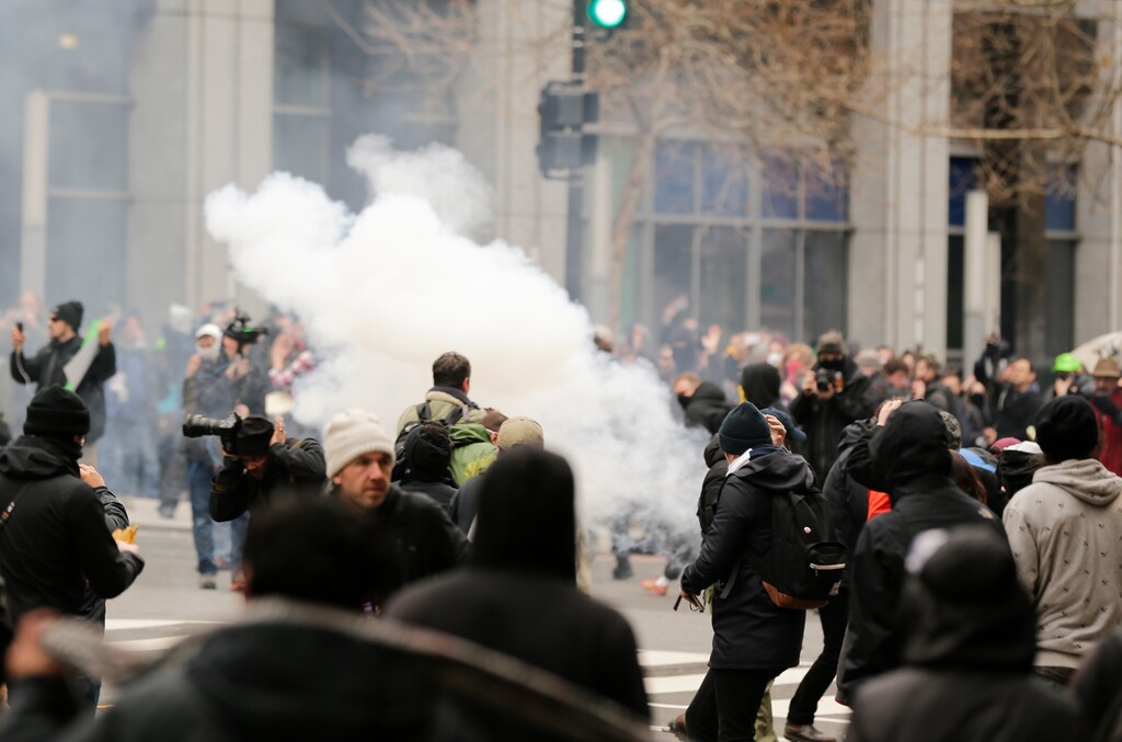 (Mark Tenally | AP) In this Jan. 20, 2017, file photo, police deploy smoke and pepper grenades during clashes with protesters in northwest Washington. When Washington police arrested more than 200 anti-Trump protesters on inauguration day 2017, it touched off a long-term battle of wits and wills. Now a federal prosecutor in Utah faces an ethics complaint for her handling of the criminal cases.