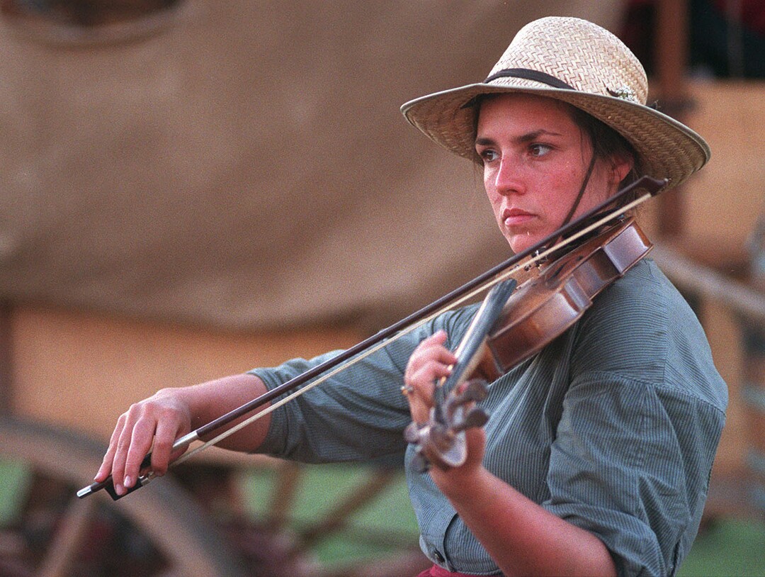 Rick Egan  | Tribune File Photo Andy Pitcher plays the fiddle, at Yellow Creek, Wyoming.