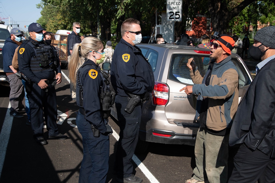 (Francisco Kjolseth  |  The Salt Lake Tribune) Police are confronted by homeless advocates as the Salt Lake County Health Department forces a clean up of homeless camps set up near Taufer Park in Salt Lake City on Thursday, Sept. 10, 2020.