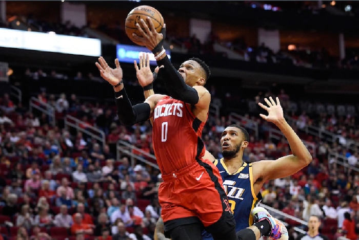 Houston Rockets guard Russell Westbrook (0) drives to the basket past Utah Jazz center Tony Bradley during the first half of an NBA basketball game, Sunday, Feb. 9, 2020, in Houston. (AP Photo/Eric Christian Smith)