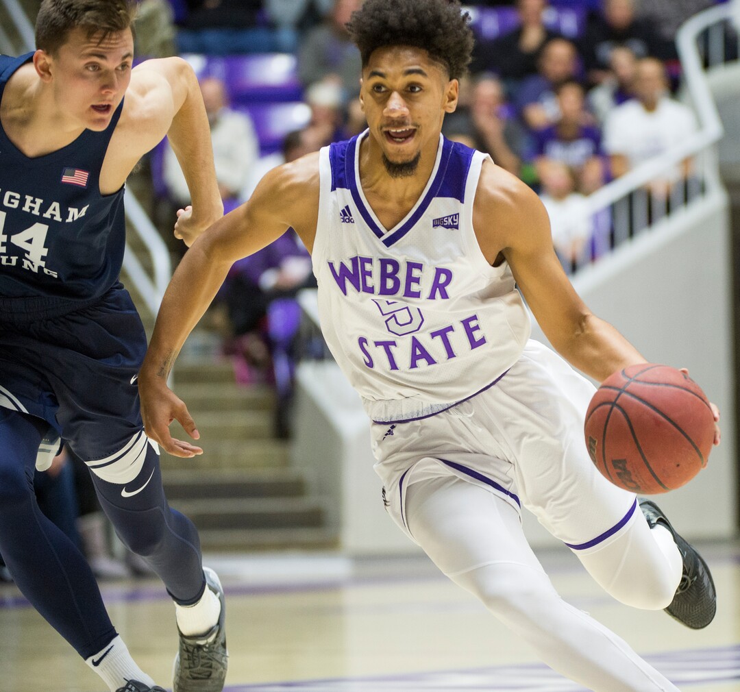 (Rick Egan  |  The Salt Lake Tribune)      Weber State Wildcats guard Cody John (5) gets past Brigham Young Cougars guard Connor Harding (44), in basketball action between Brigham Young Cougars and Weber State Wildcats, at the Dee Event Center in Ogden, Saturday, Dec. 1, 2018.