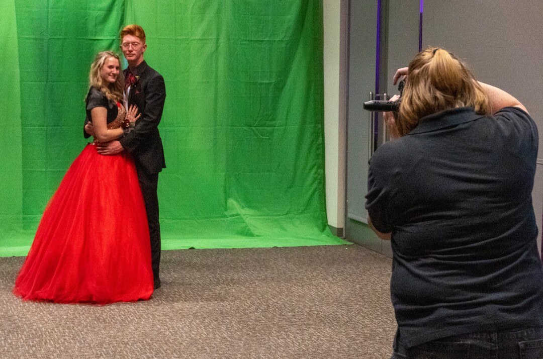 (Rick Egan | The Salt Lake Tribune) Raegan Huefner Isaac Burris remove their masks as they pose for their official prom photo, during the Cypress High school Prom, on Saturday, April 24, 2021.
