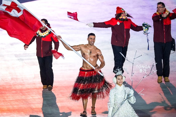 (Chris Detrick  |  The Salt Lake Tribune)  Pita Taufatofua carries the flag of Tonga during the Pyeongchang 2018 Winter Olympics opening ceremony at Olympic Stadium Friday, February 9, 2018.  