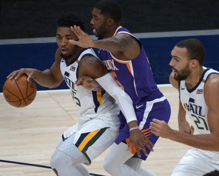 (Leah Hogsten | The Salt Lake Tribune) Phoenix Suns guard Cameron Payne (15) pressures Utah Jazz guard Donovan Mitchell (45) as the Jazz crack open their 2020-21 preseason with their second game against the Phoenix Suns, Dec. 14, 2020.