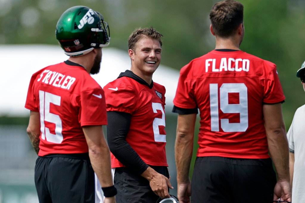 (Adam Hunger | AP) New York Jets quarterback Zach Wilson (2) laughs with quarterbacks Joe Flacco (19) and Chris Streveler during a break in drills at the NFL football team's practice facility in Florham Park, N.J., last Thursday.