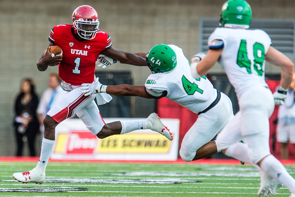 (Chris Detrick  |  The Salt Lake Tribune)  Utah Utes quarterback Tyler Huntley (1) runs past North Dakota Fighting Hawks linebacker Donnell Rodgers (44) during the game at Rice-Eccles Stadium Thursday, August 31, 2017. Utah Utes are leading North Dakota Fighting Hawks 17-9 at halftime. 