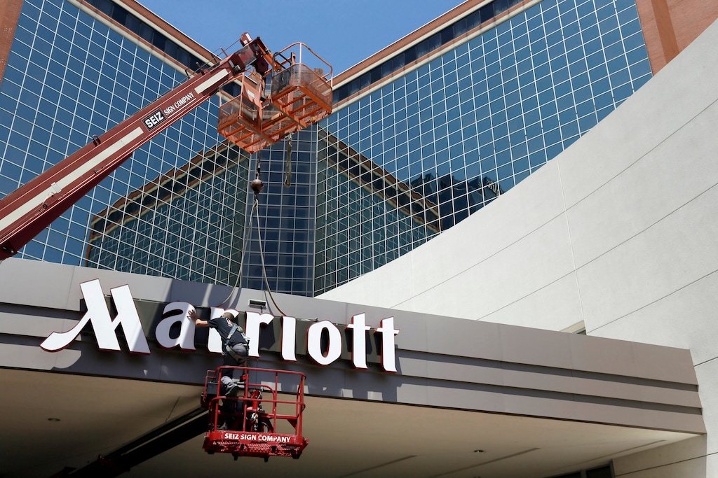 (Danny Johnston | The Associated Press) In this Tuesday, April 30, 2013, file photo, a man works on a new Marriott sign in front of the former Peabody Hotel in Little Rock, Ark. Marriott says the information of up to 500 million guests at its Starwood hotels has been compromised. It said Friday, Nov. 30, 2018, that there was a breach of its database in September, but also found out through an investigation that there has been unauthorized access to the Starwood network since 2014.