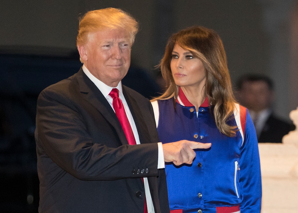 President Donald Trump and his wife, Melania, view the Florida Atlantic University Marching Band at Trump International Golf Club in West Palm Beach, Fla., Sunday, Feb. 4, 2018, as they arrive for a Super Bowl party. (AP Photo/Carolyn Kaster)